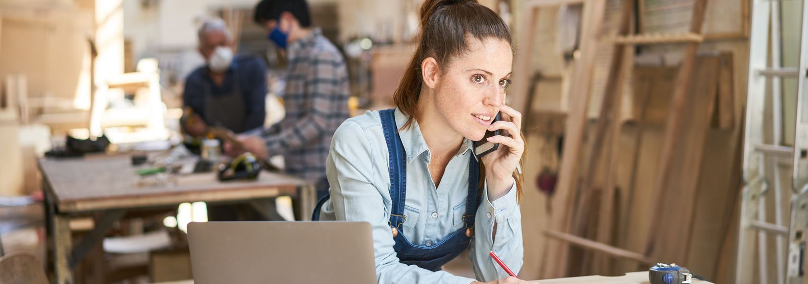 Carpenter talking on the phone with a customer