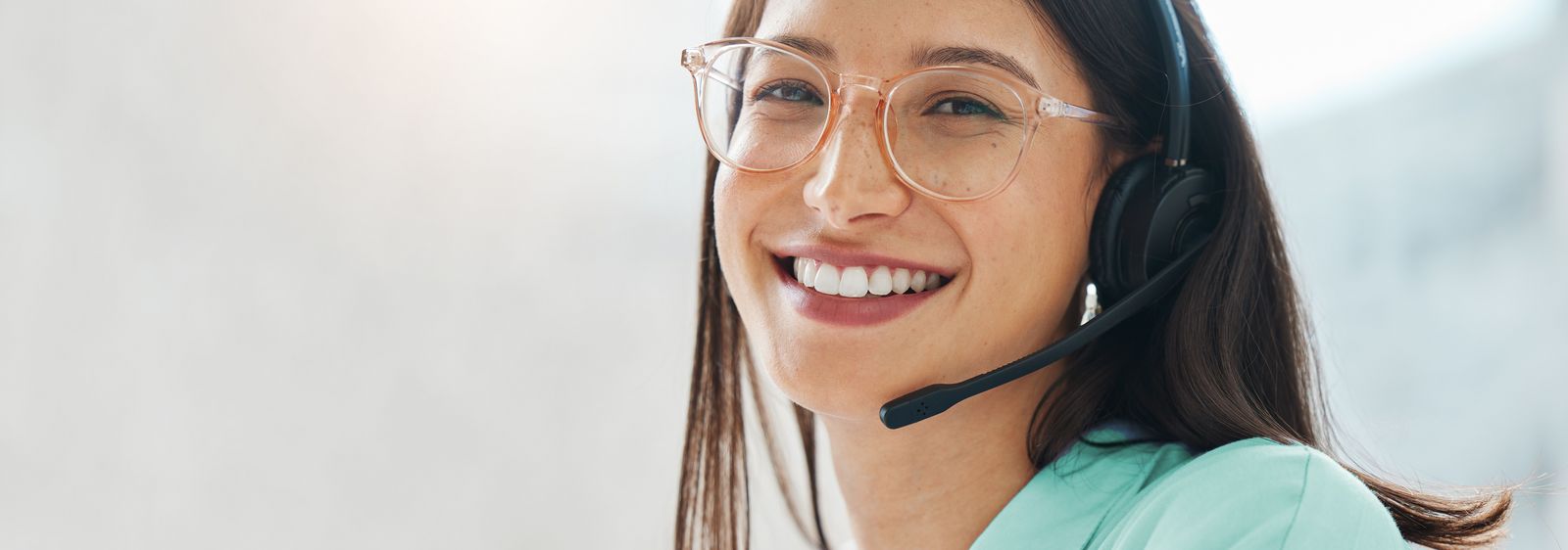 A young call centre representative greets a caller